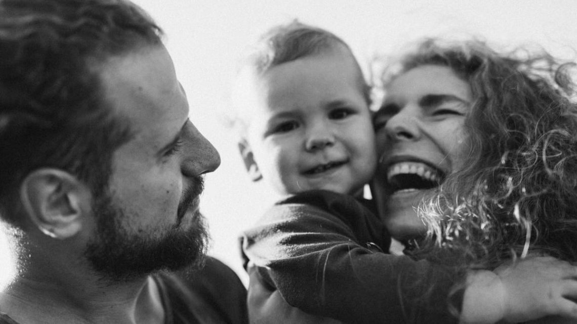 A happy family enjoying a heartfelt moment together in a black-and-white setting.