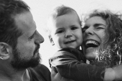 A happy family enjoying a heartfelt moment together in a black-and-white setting.