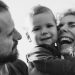 A happy family enjoying a heartfelt moment together in a black-and-white setting.